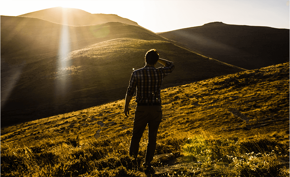 Do you feel like businesses are searching for your company but unable to find it? Man stanind on a hilltop in Quchan, Iran searching the horizon